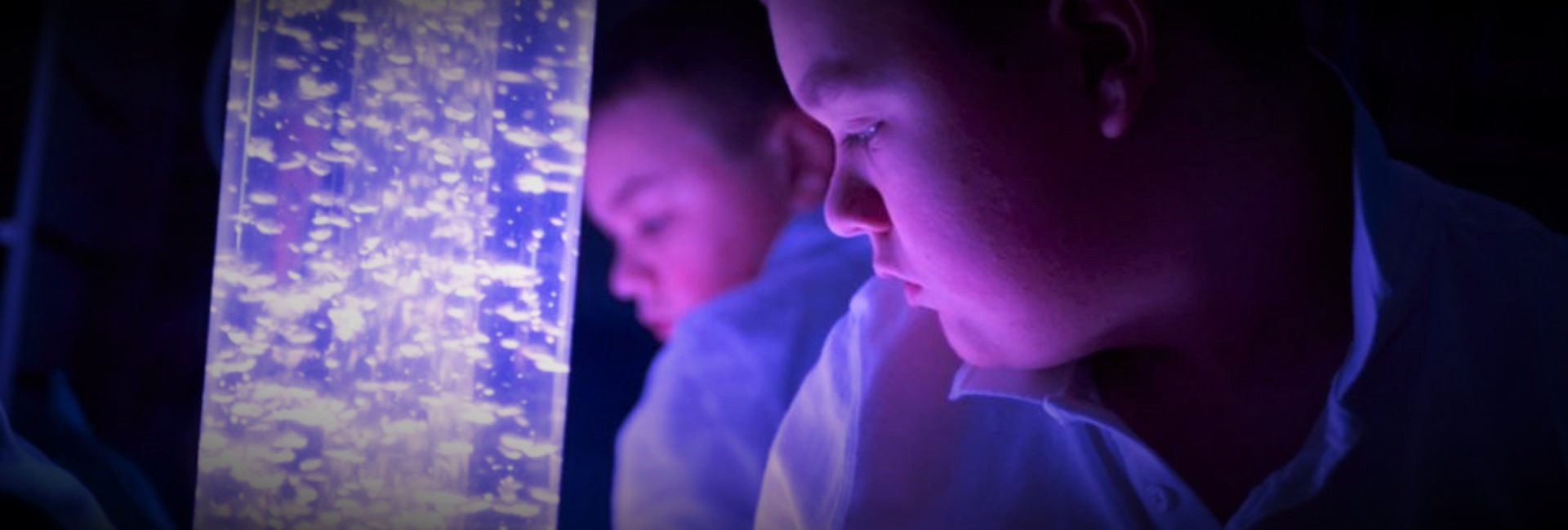 Children in front of a bubble tower light